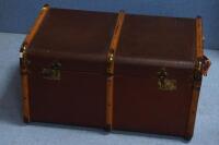 A brass and beech banded canvas covered travel trunk