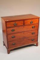 A George III mahogany chest of two short and three long graduated drawers