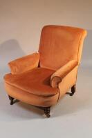 A Victorian walnut low armchair in the manner of Howard