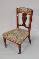 An Edwardian rosewood marquetry nursing chair