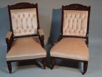 A pair of Edwardian upholstered easy chairs.