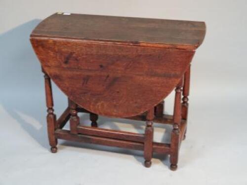 An 18thC and later oak gateleg dining table