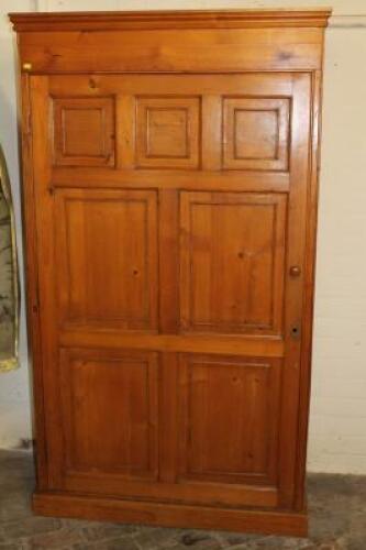 A stained pine cupboard