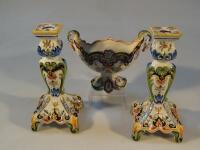 A French faience earthenware boat-shape vase and pair of matched candlesticks