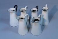 Six enamel water jugs.