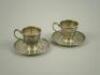 A pair of Tiffany & Co sterling silver coffee cups and saucers