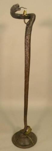 After Edgar Brandt. A bronze floor lamp in the form of a snake