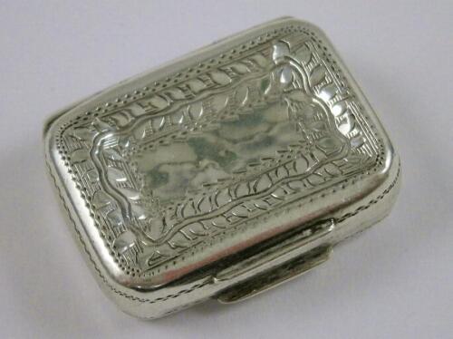 A George III silver vinaigrette of small rectangular form with floral motifs and canted corners
