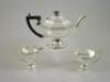 A silver three piece tea service