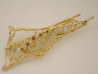 An 18ct gold and ruby set spider web brooch