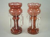 A pair of Bohemian type cranberry tinted cut glass table lustres