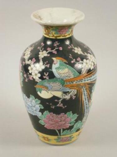 A Japanese vase decorated with Asiatic pheasants on a black ground