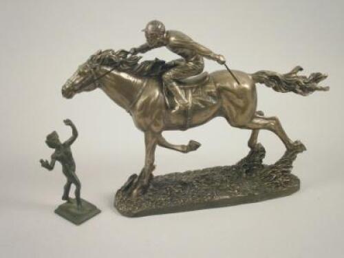 A bronze resin figure of a jockey on horseback