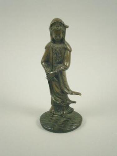 An oriental bronze figure of Guan Yin