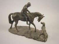 A bronzed resin figure of a huntsman and hound