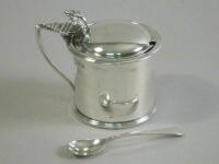 A silver cylindrical mustard pot and spoon