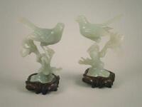 A pair of green hardstone carved figures of birds