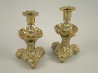 A pair of brass Rococo style continental candlesticks