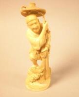 A Japanese brown stained ivory figure