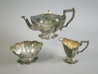 A silver three piece tea service