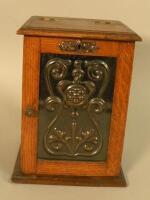 An Art Nouveau style oak tobacco cabinet