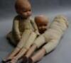 Two modern reproduction bisque headed dolls