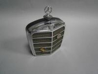 A novelty radio in the form of a Mercedes Benz grille