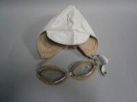 A pair of cream leather goggles and a leather helmet