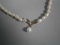 A pearl necklace with drop and clasp