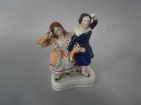 A Victorian Staffordshire figure group of a man and woman in dance