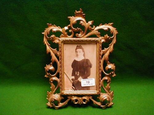 A gilt metal photograph frame