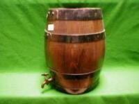 A wooden coopered sherry barrel with metal tap