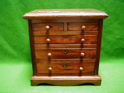 A mahogany miniature chest of drawers with 2 short and 3 long drawers