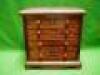 A mahogany miniature chest of drawers with 2 short and 3 long drawers