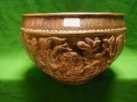 A Benares brass planter chased with a continuous hunting scene with wild