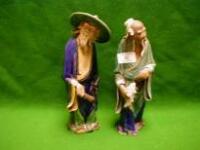 A pair of early 20thC part-glazed Chinese figures of village elders