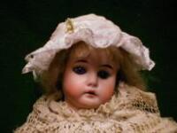 A German bisque headed doll with blue glass eyes