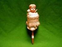 A German poupard, having celluloid head and bead trimmed dress, 13" high,