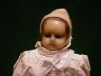 A doll with wax head and limbs and cloth body