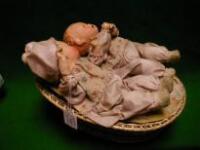 A German clockwork wicker crib with 2 baby dolls with automaton movement