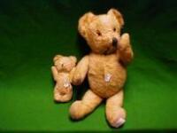 Two golden plush teddy bears with articulated limbs