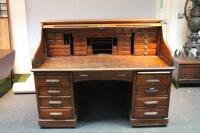 An early 20thC large oak roll top desk