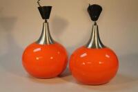 A pair of 1970s orange glass light fittings