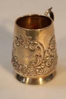 An Edwardian silver small repousse chased tankard