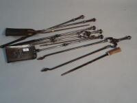 Various cast metal fire irons.