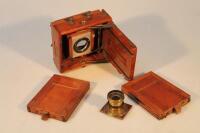 An antique quarter plate camera and two lenses.