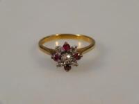 An 18ct gold ruby and diamond cluster dress ring