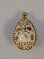 An alabaster egg shaped pendant