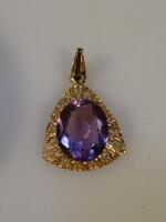 A filigree pendant set with a pale amethyst