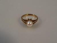 A 9ct gold dress ring set with a pearl.